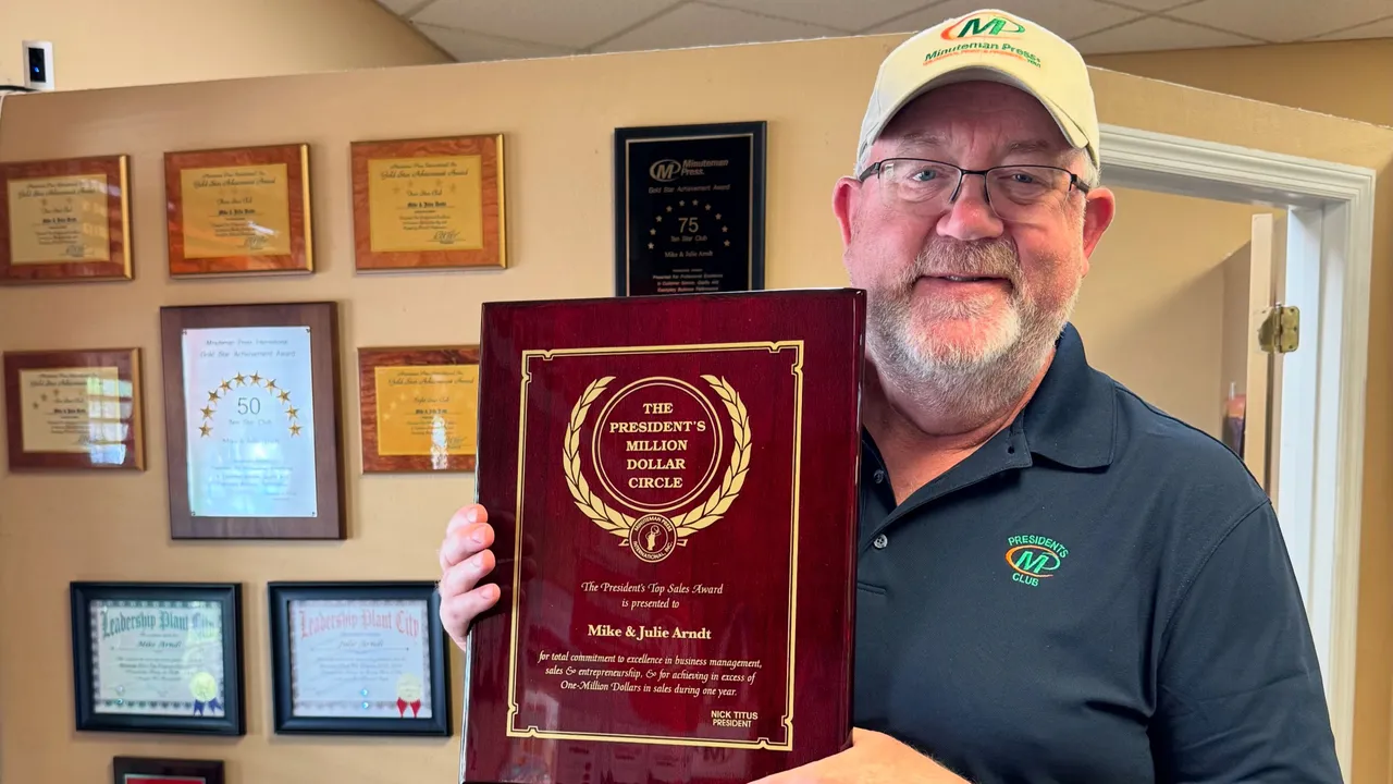 Minuteman Press Franchise Owner Mike Arndt with his President’s Club Award in Plant City, FL.
