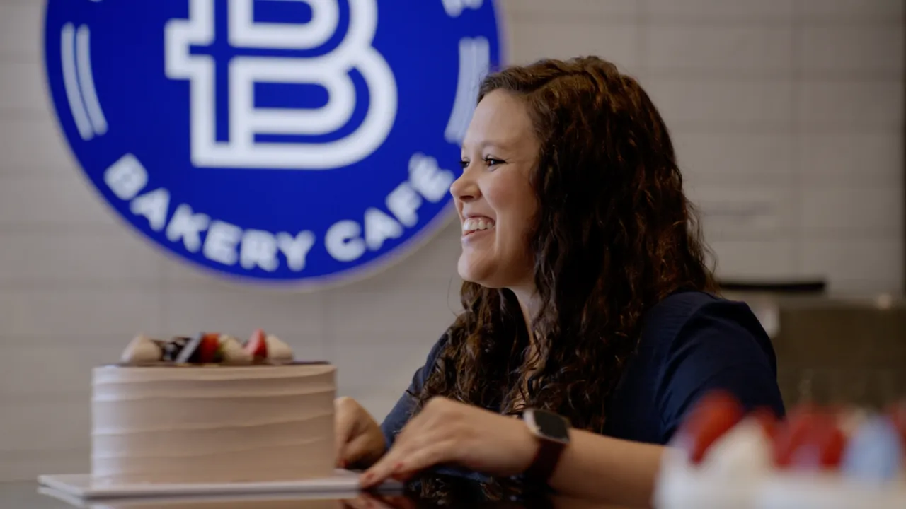 Photo of person in Paris Baguette café passing cake over countertop