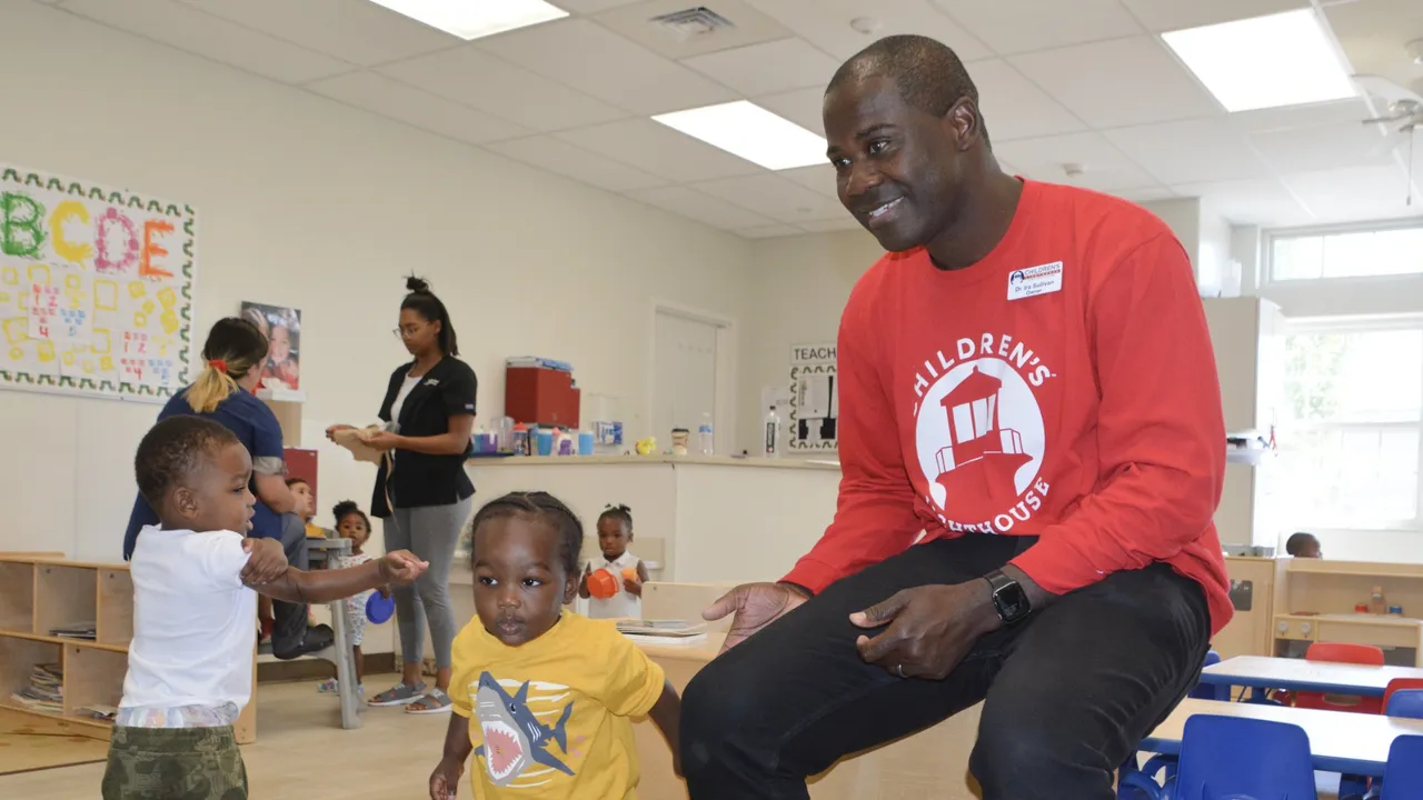 image of a children's lighthouse franchise employee teacher working with kids