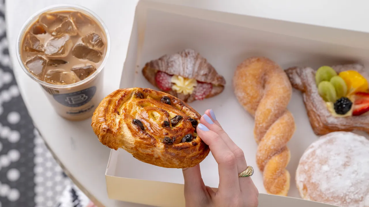 image of a paris baquette pastry being picked out of a box