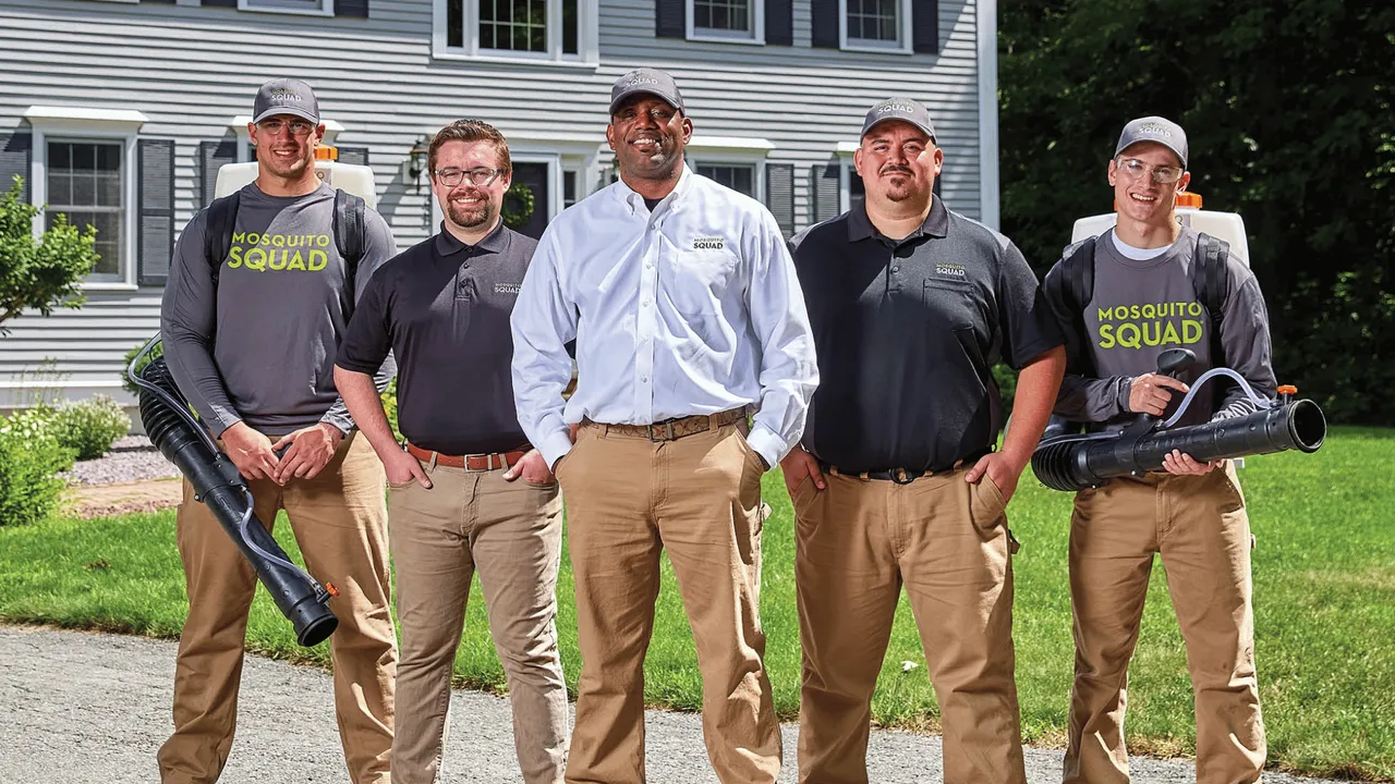 image of mosquito squad franchise team in front of a nice home