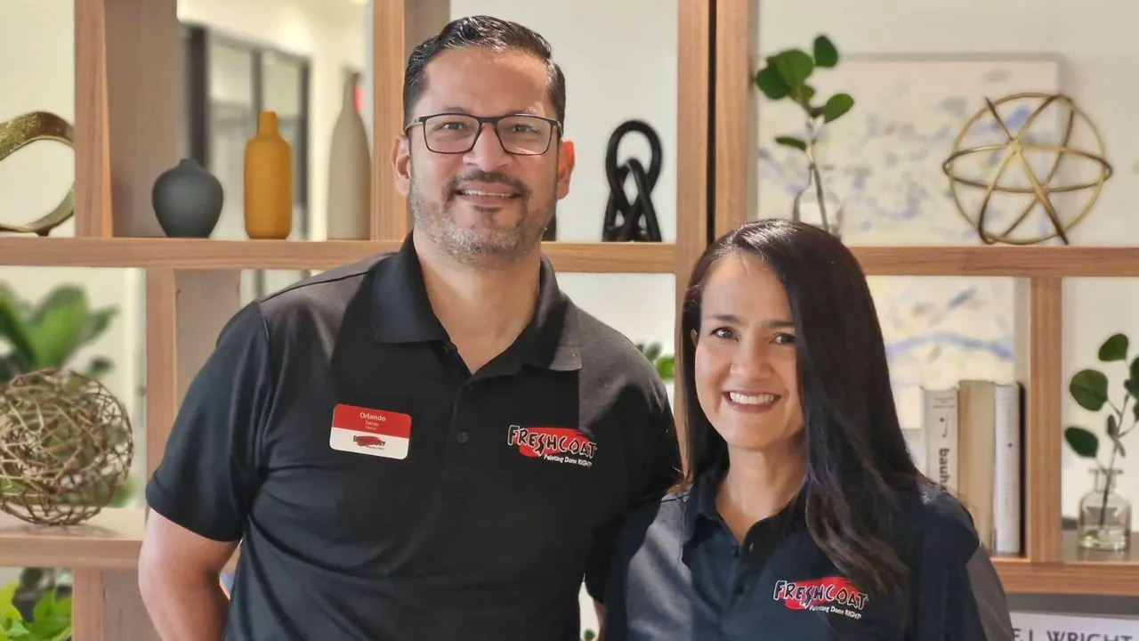 Photo of two Fresh Coat franchise owners wearing branded polos