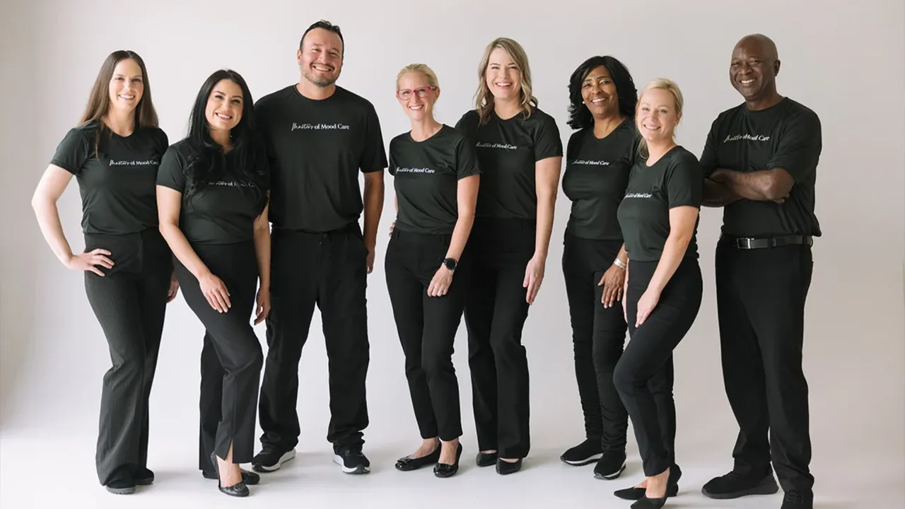 Photo of diverse team of Woodhouse Spa team members standing together, smiling