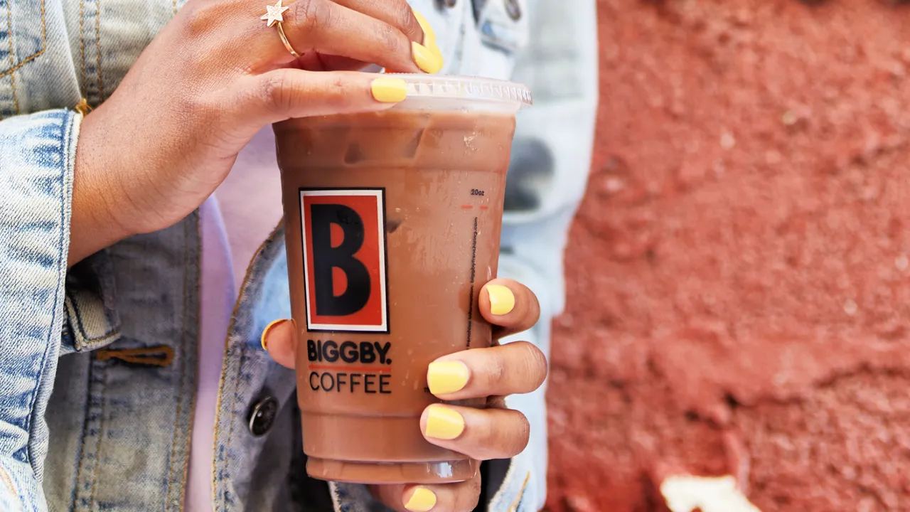 Photo of person holding iced BIGGBY COFFEE beverage