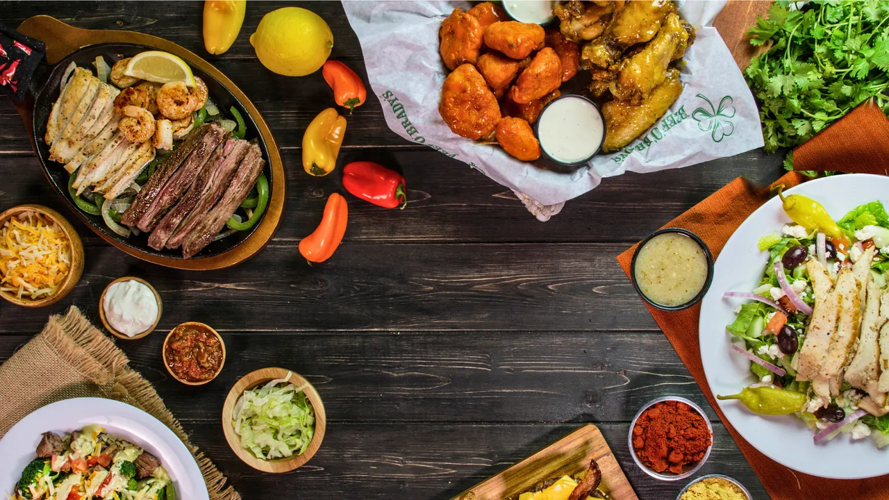 Photo of multiple Beef 'O' Brady's plates on table
