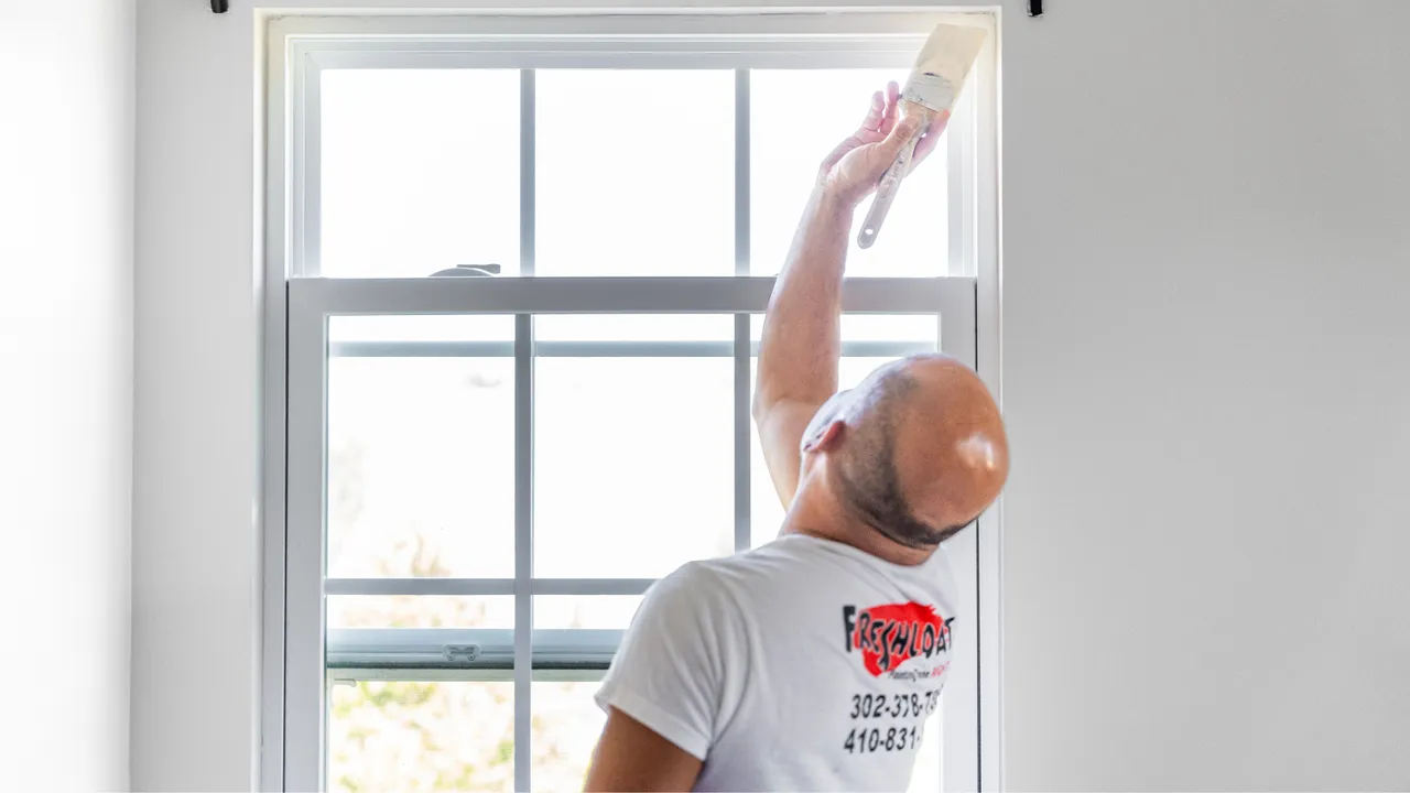 Photo of Fresh Coat team member painting window