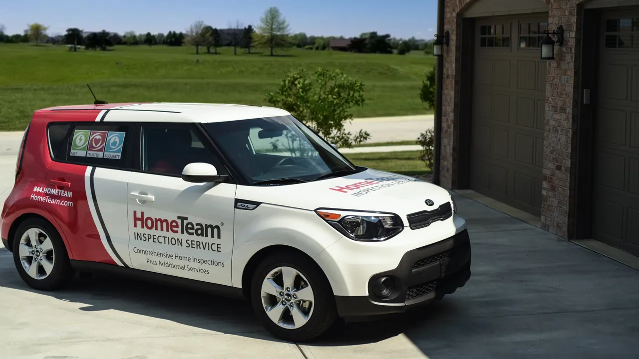 Photo of HomeTeam Inspection Service branded vehicle parked outside home