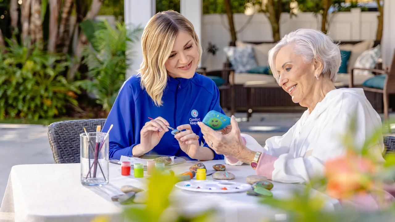 Photo of Comfort Keepers team member and senior completing craft project
