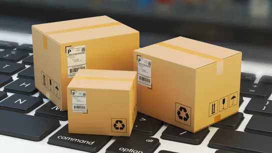 Delivery boxes sitting on a computer for online delivery