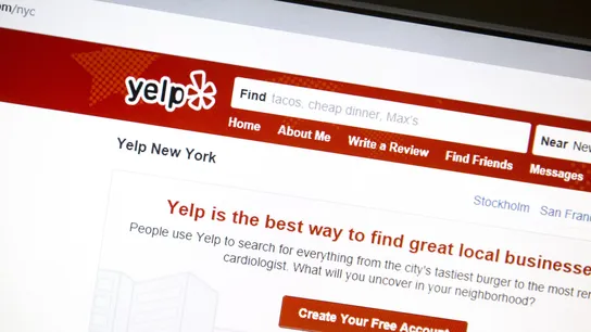 A photo of the website Yelp on a computer