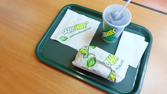 Subway sandwich and drink on a tray.