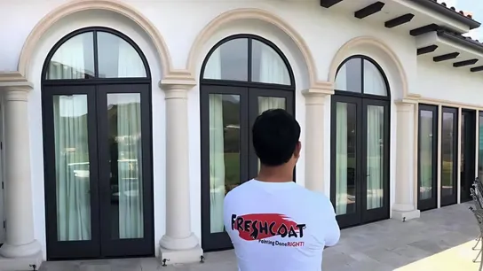 Photo of Fresh Coat painter standing outside, looking at completed project