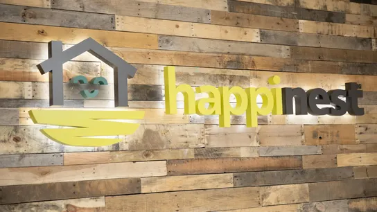 image of a happiness business franchise logo on a wood wall on location