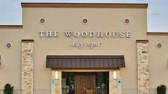 Photo of exterior of Woodhouse Spa location with wooden doors 
