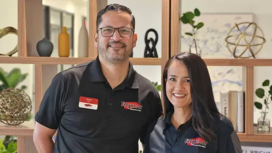 Photo of two Fresh Coat franchise owners wearing branded polos