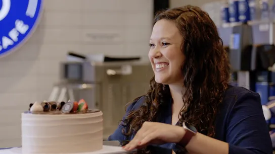 image of paris baguette franchise owner franchisee in a bakery with a cake
