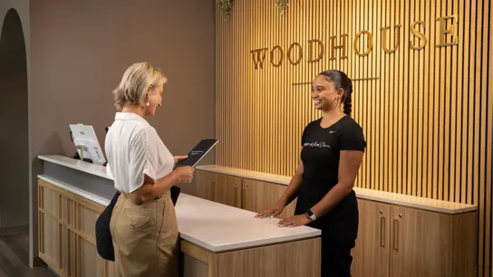 Photo of guest checking in at Woodhouse Spas reception desk