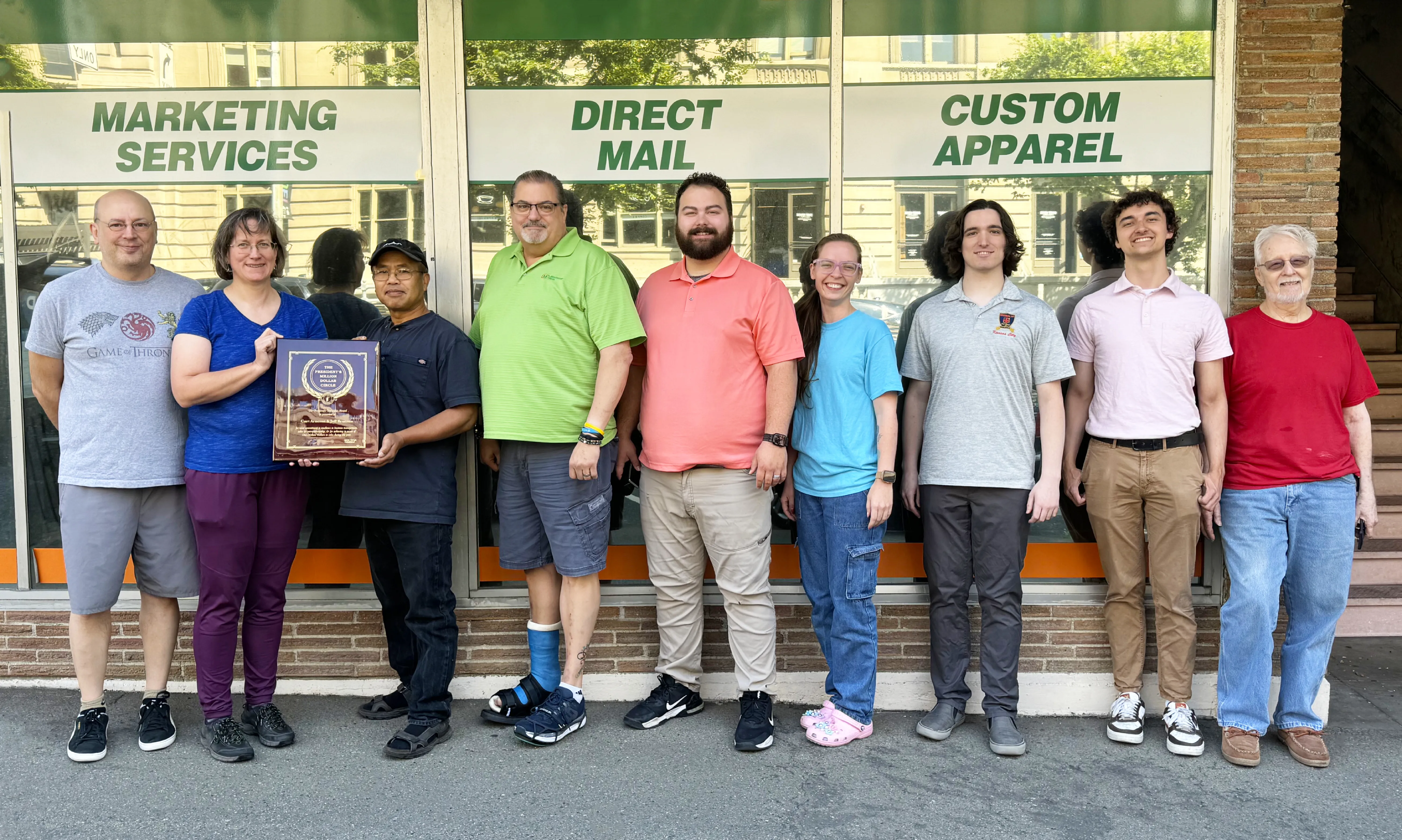  Minuteman Press franchise owner Jeff Brunson (4th from left) and team with President's Club Award