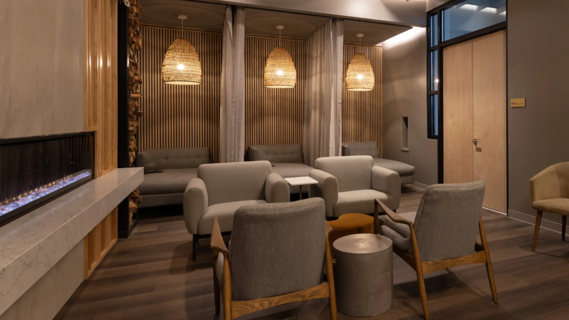 photo of interior of a Woodhouse Spas room featuring multiple chairs and soft pendant lighting