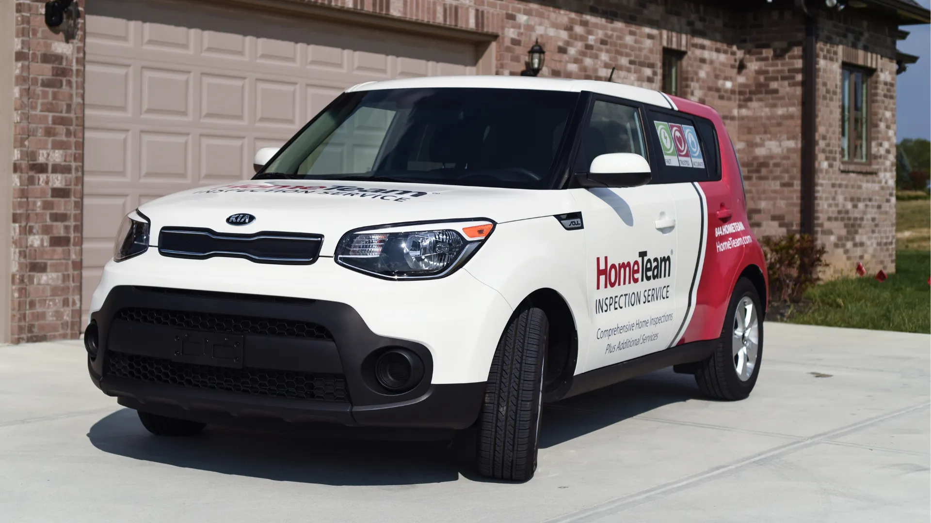 HomeTeam branded vehicle parked in front of a brown home