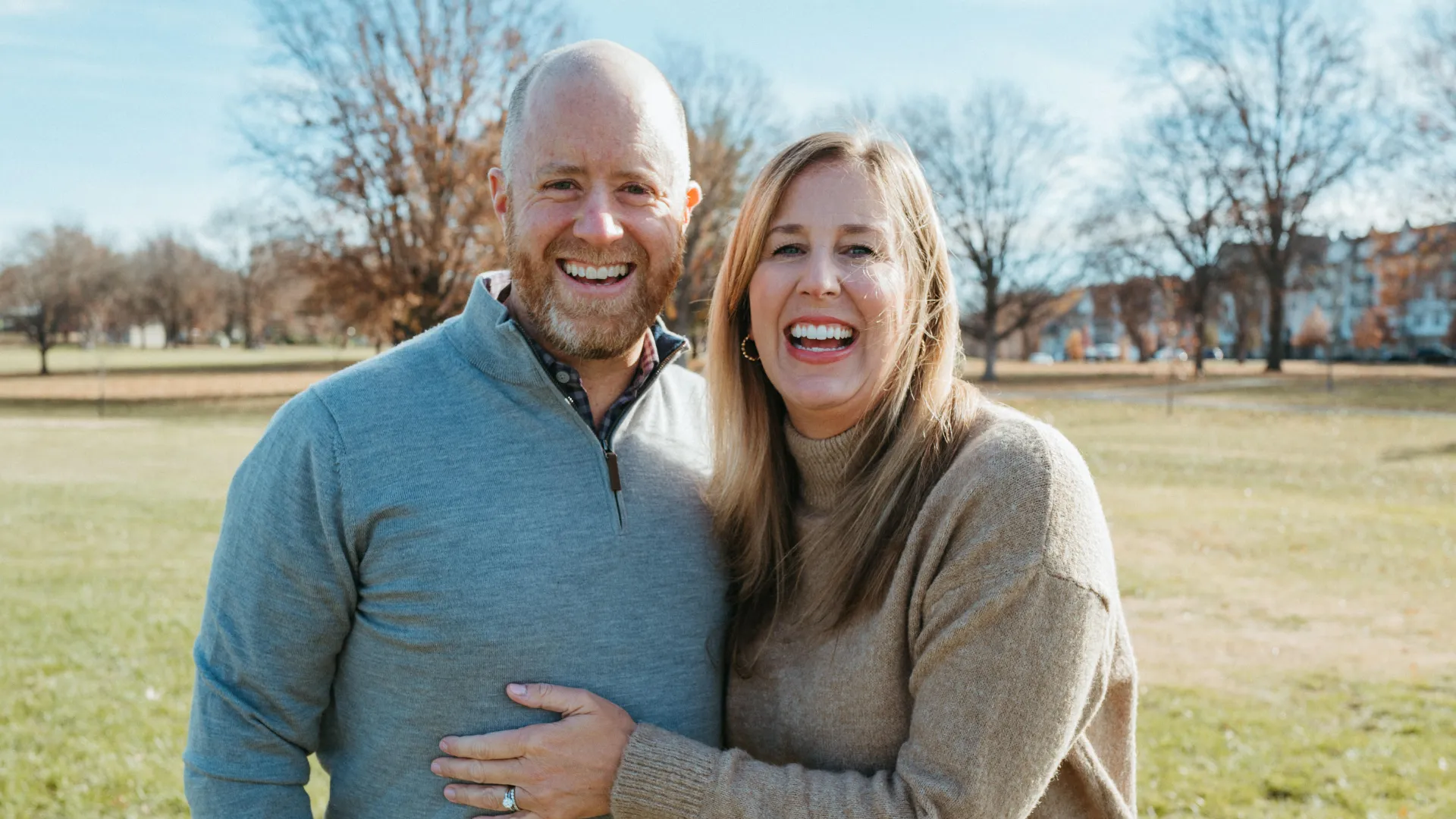 photo of Mark and Julie Rome, standing outdoors and smiling at the camera