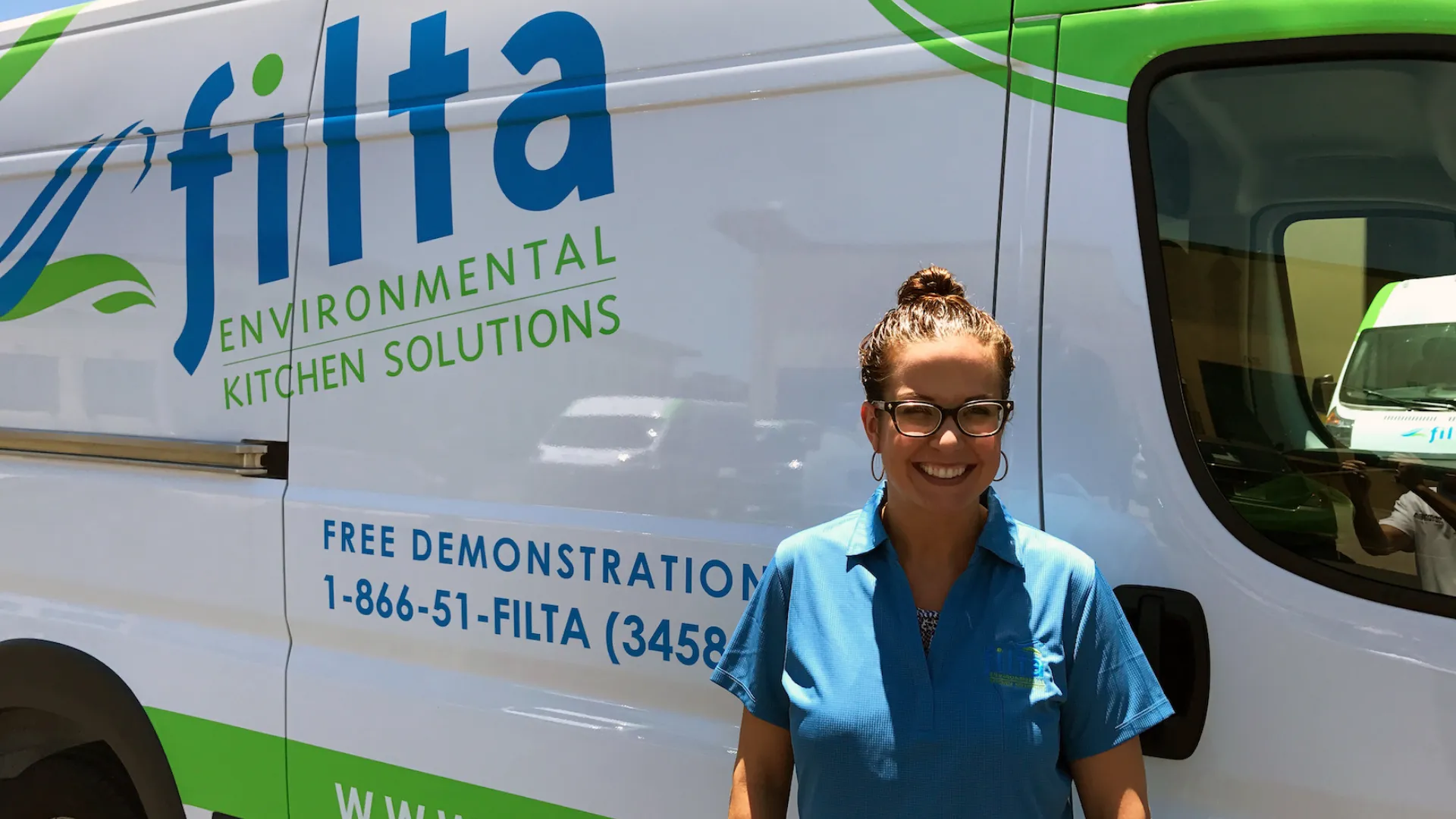 photo of Filta franchisee Lauren Wanco staning in front of branded vehicle