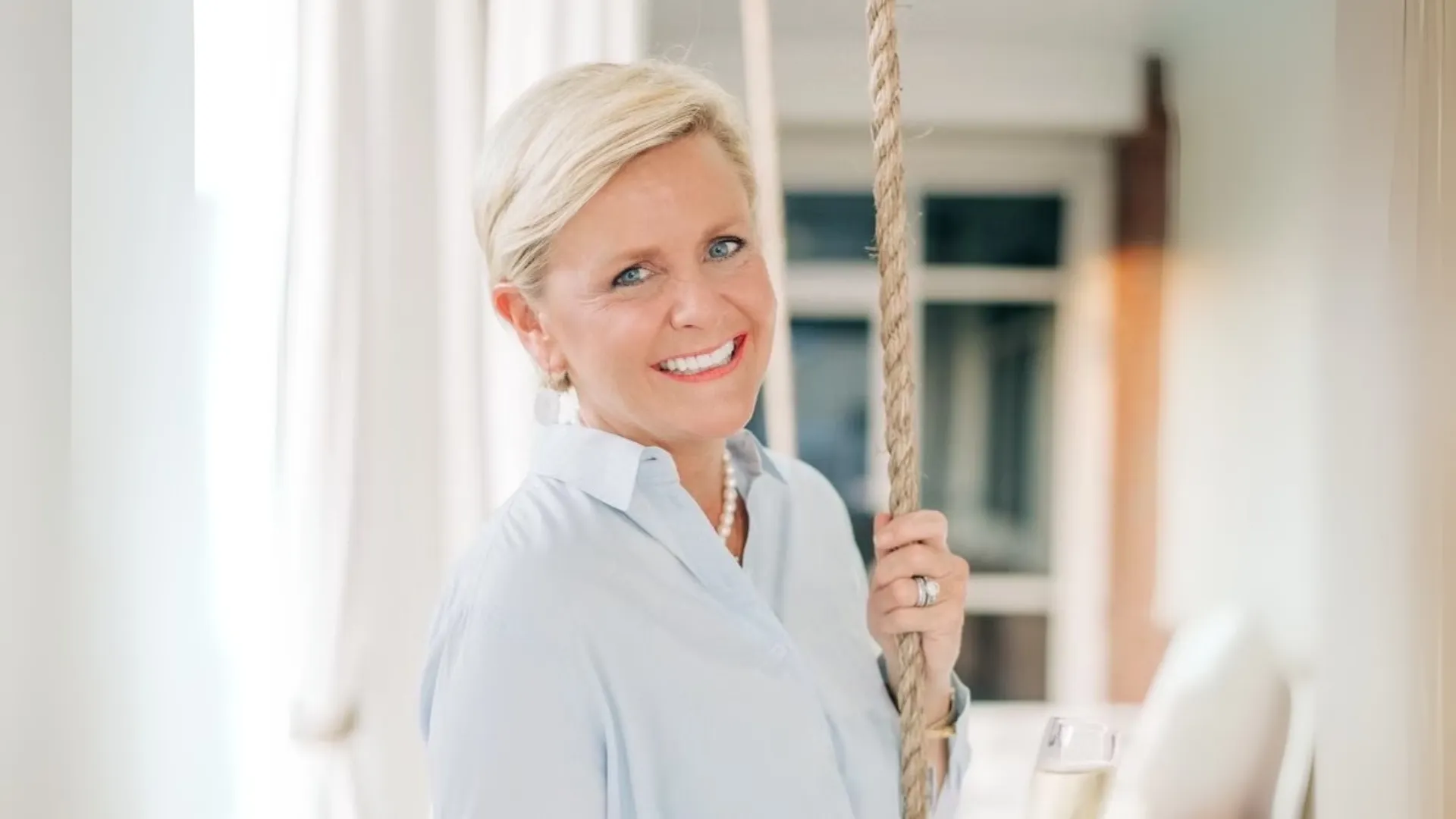 photo of Woodhouse Spas franchisee Kimberly Powell smiling at the camera, wearing a light blue shirt