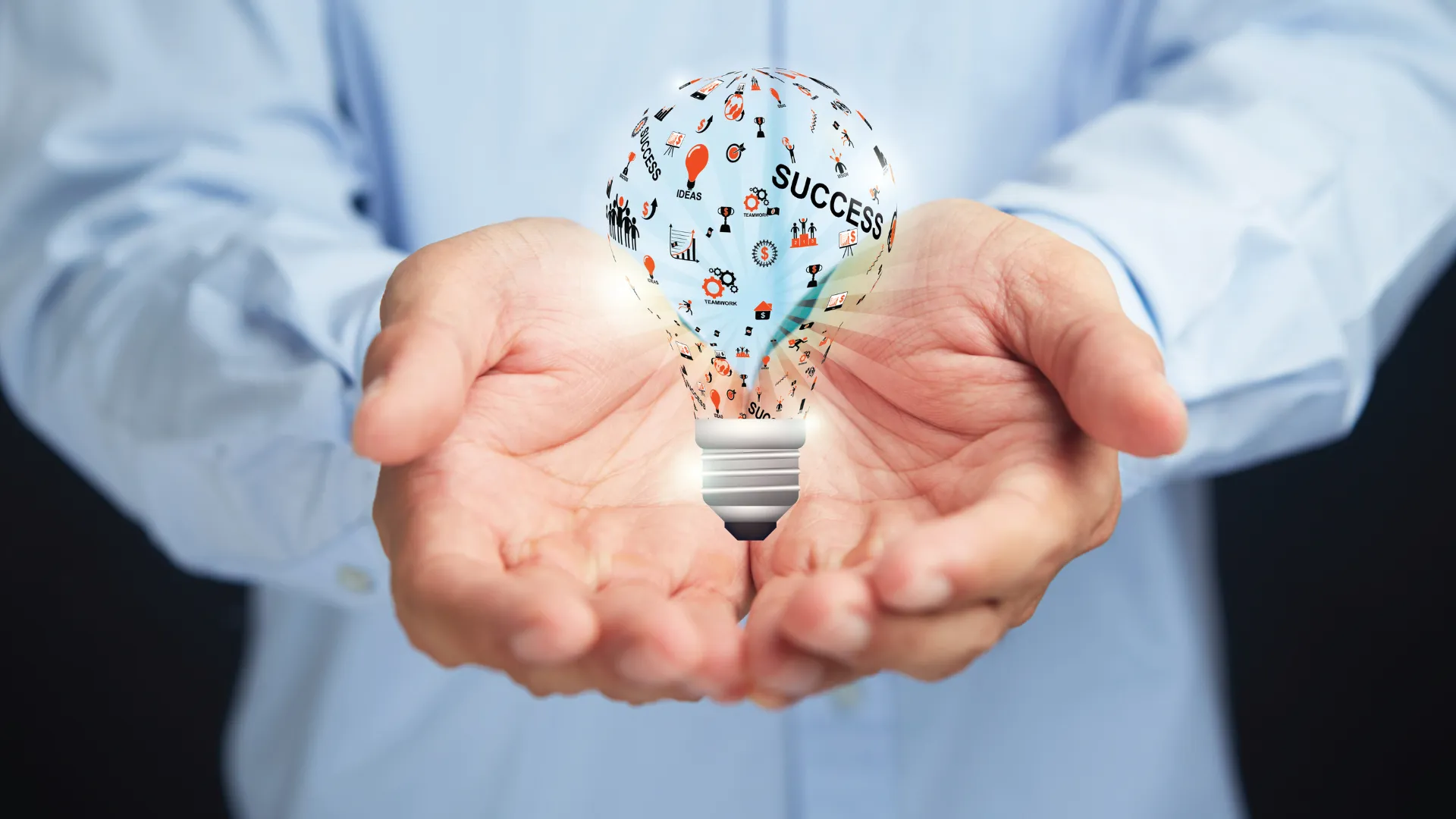 Image of two hands holding lightbulb 