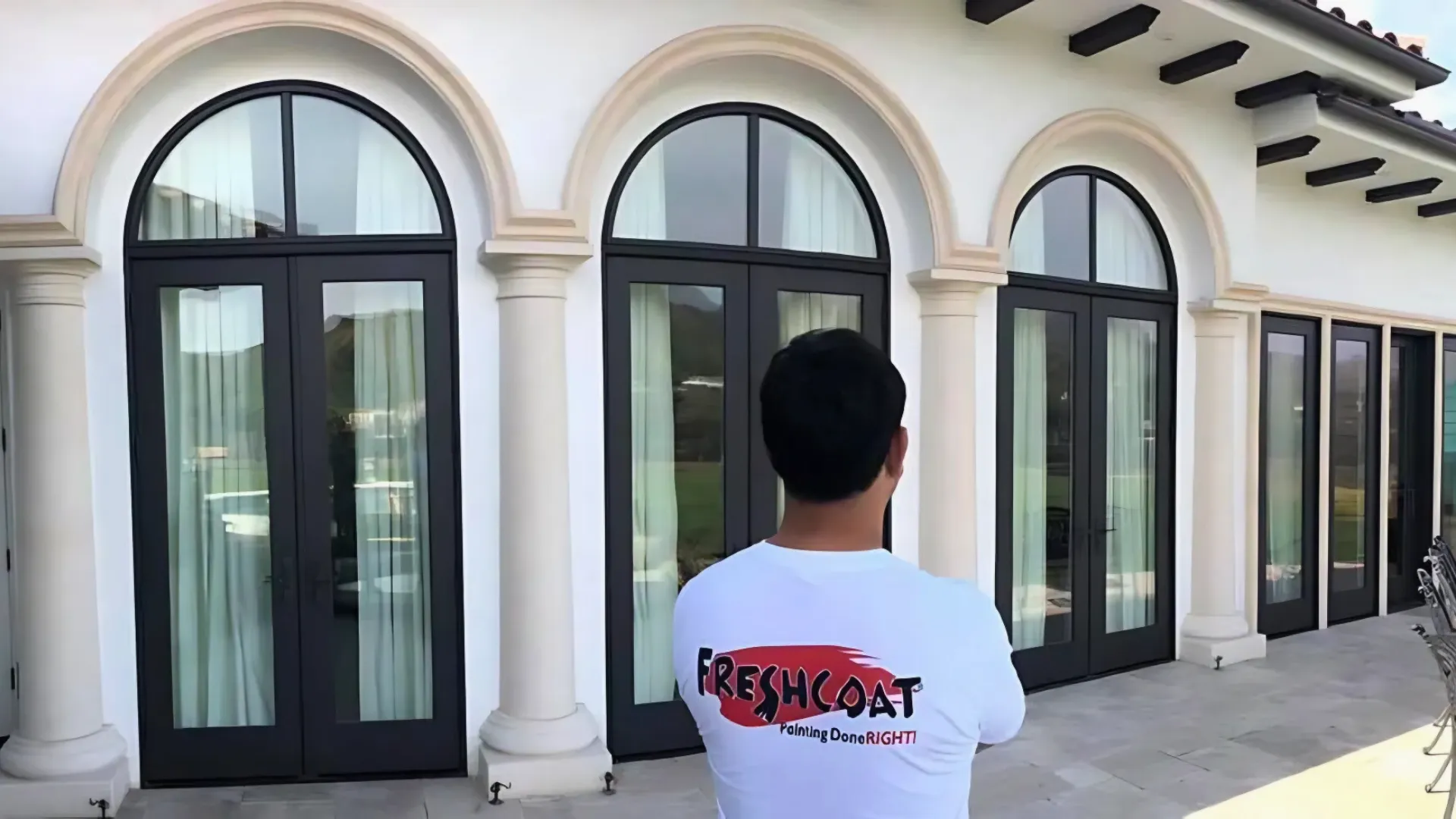 Photo of Fresh Coat painter standing outside, looking at completed project