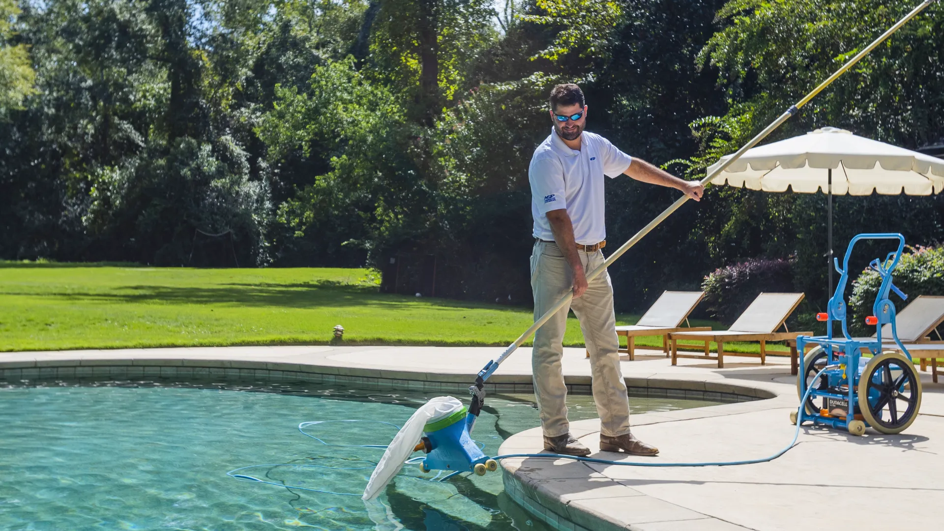 image of a americas swimming pool employee cleaning a spotless pool franchise success