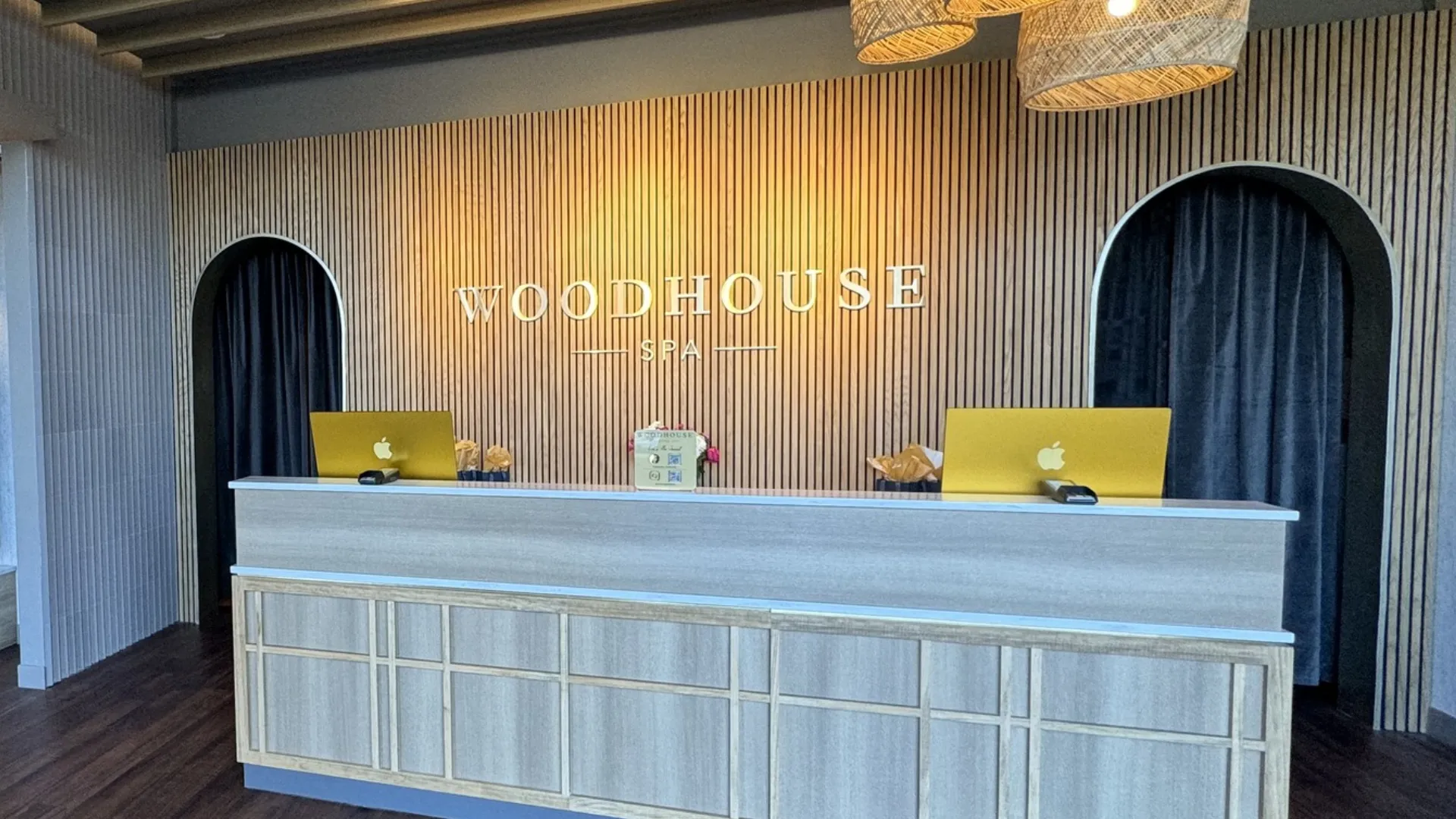 Photo of interior of Woodhouse Spa featuring front desk and wooden paneled wall