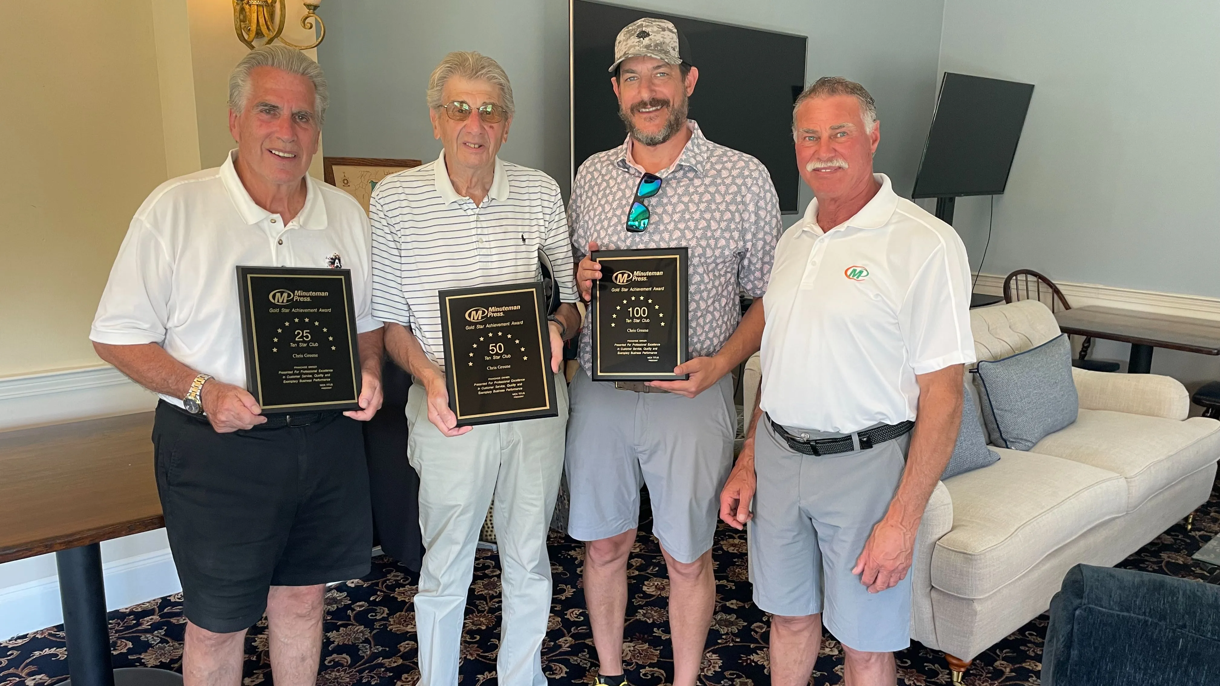 Minuteman Press franchise owner Chris Greene (3rd from left) thrives after buying 2 NY print shops.