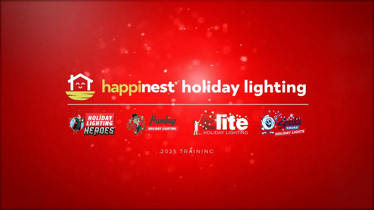 Photo of Humbug Holiday Lighting team members wearing festive sweaters, beanies, smiling at camera