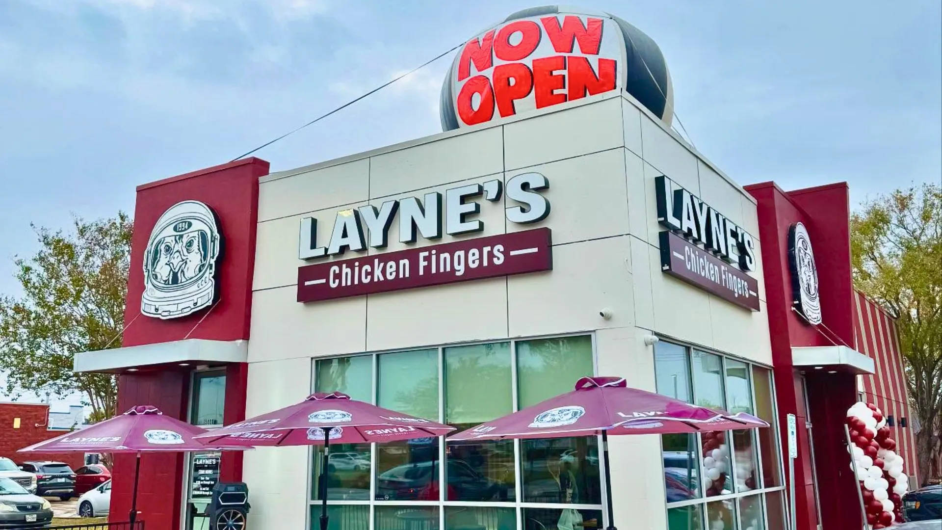 Photo of Layne's Chicken Fingers restaurant with "Now Open" inflatable on roof