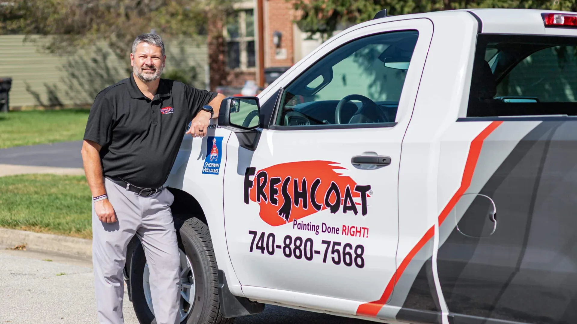 Photo of Fresh Coat owner standing by branded vehicle