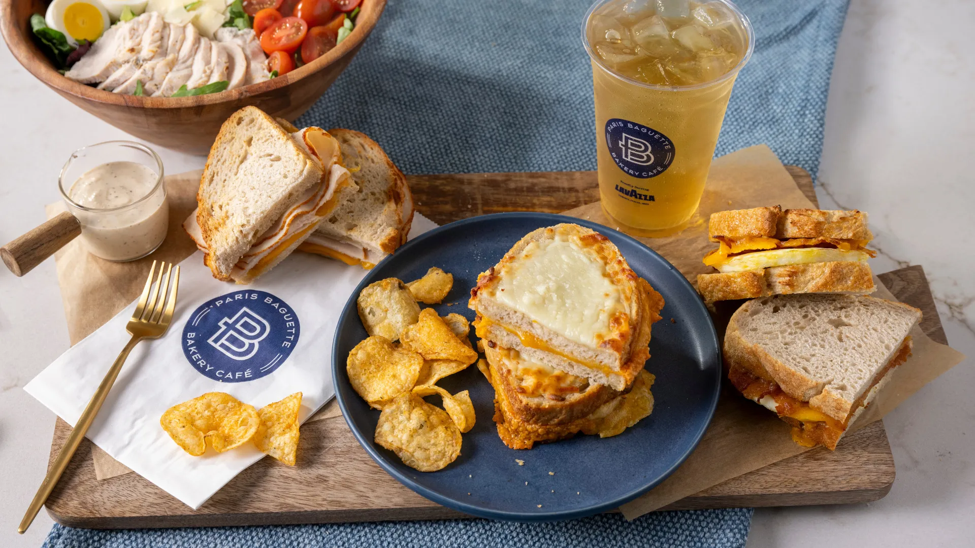 Photo of Paris Baguette spread of sandwiches, chips, salad and beverage
