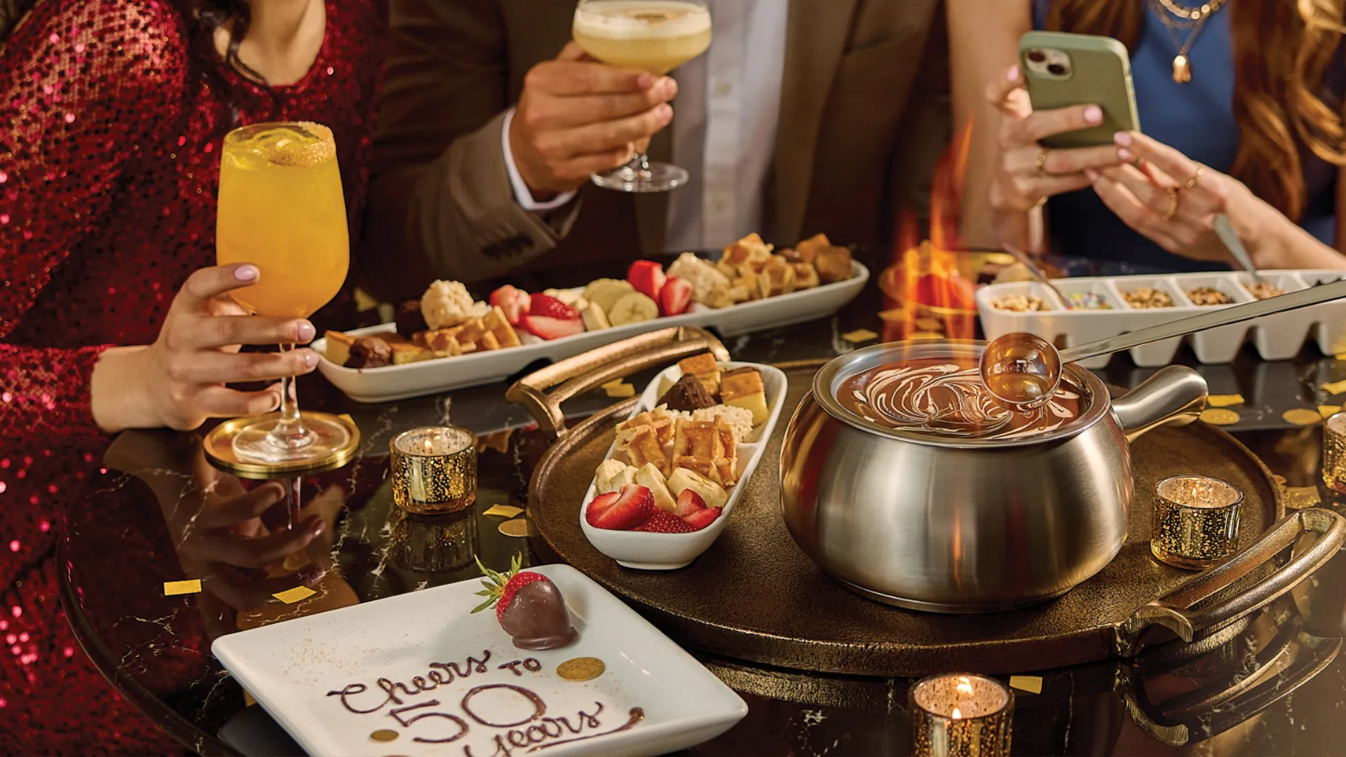 Photo of Melting Pot table with chocolate fondue and "Cheers to 50 Years" plate