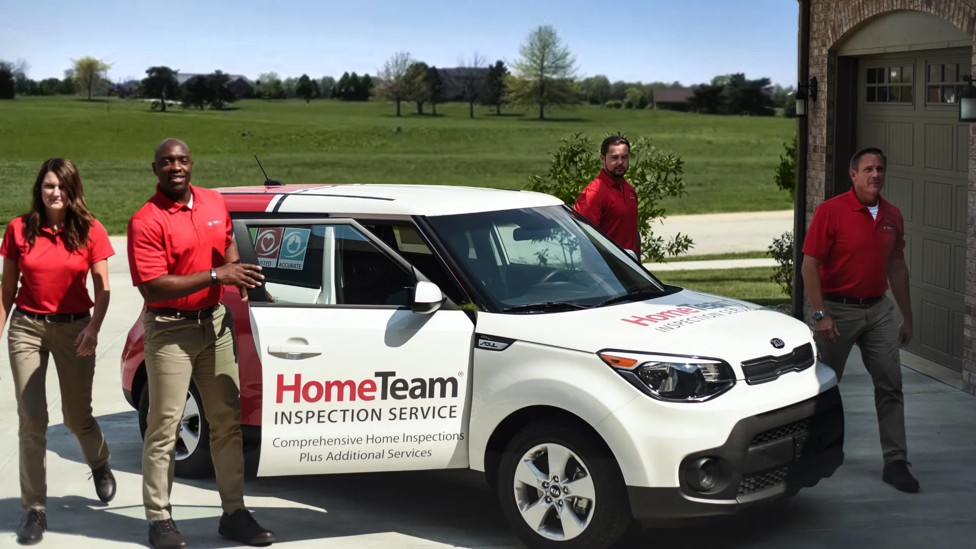 Photo of four HomeTeam inspectors exiting branded vehicle