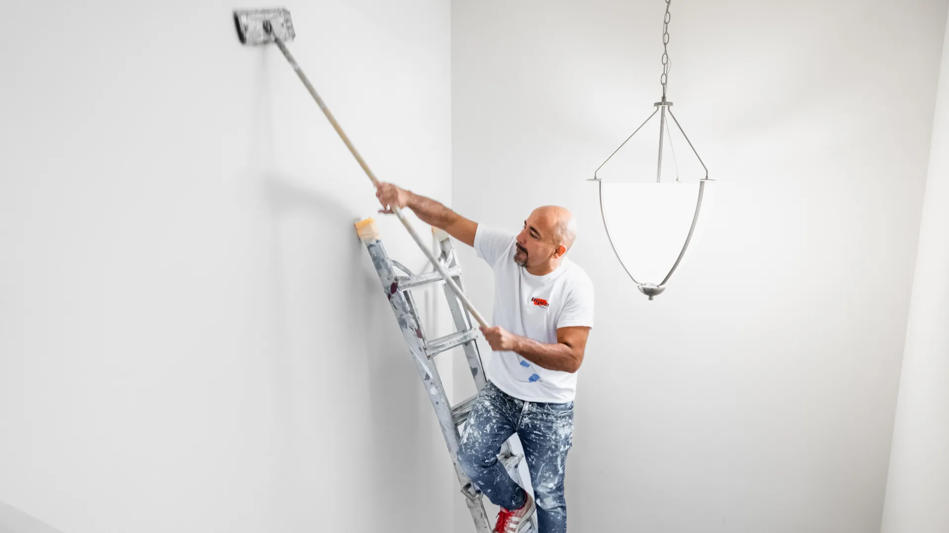 Photo of Fresh Coat Painters team member working on ladder