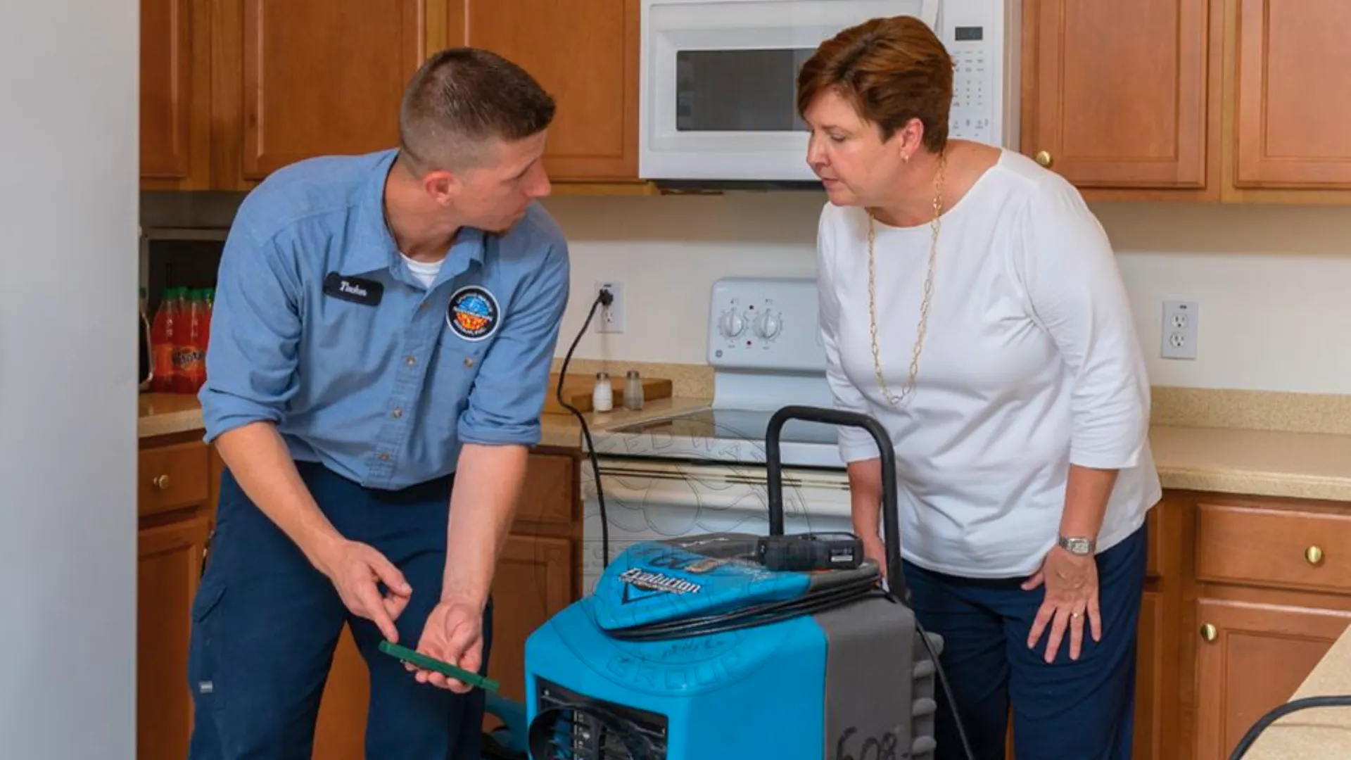 an image of united water restoration group home services franchise employee working with a customer