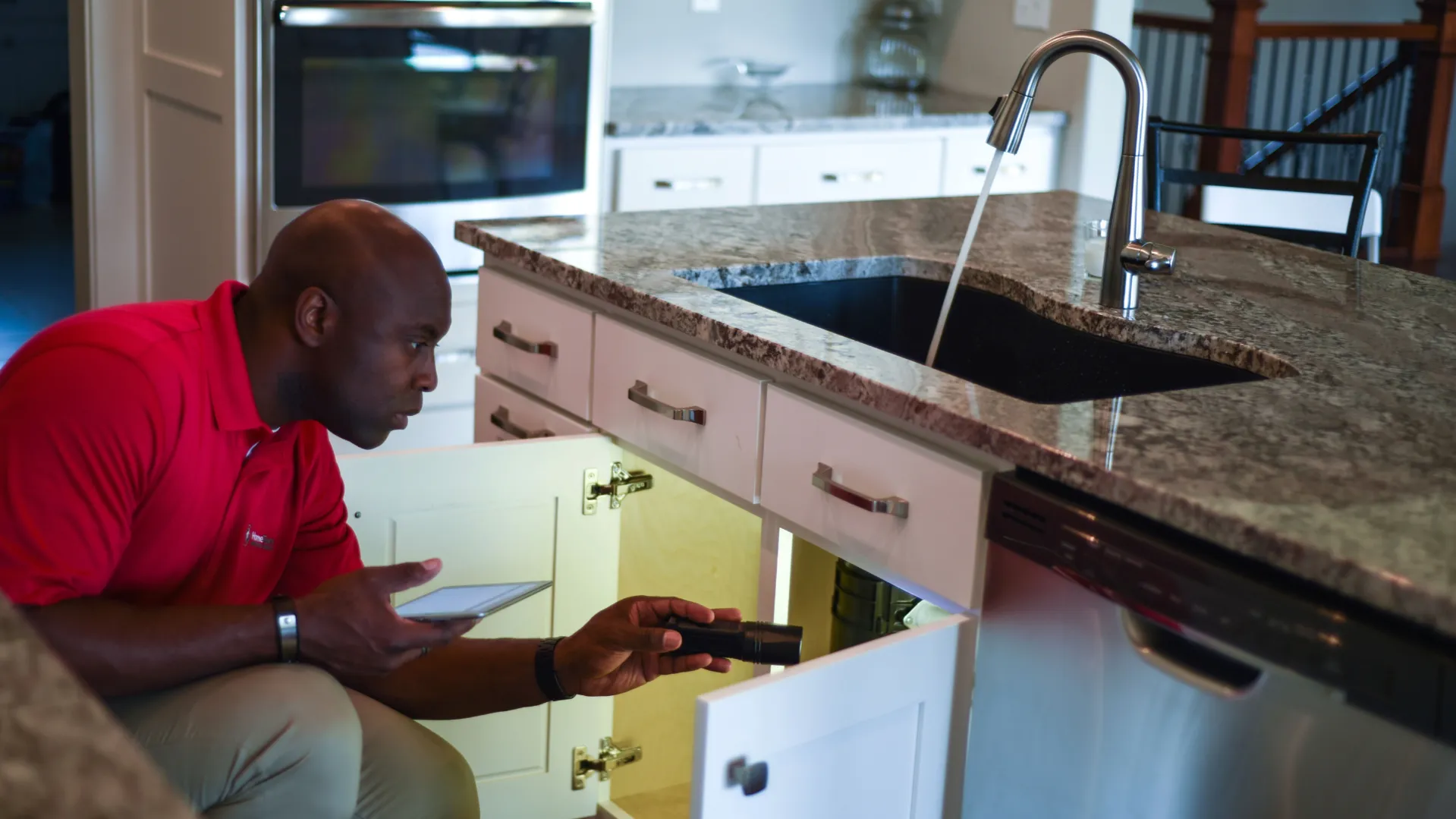 Photo of HomeTeam inspector in kitchen