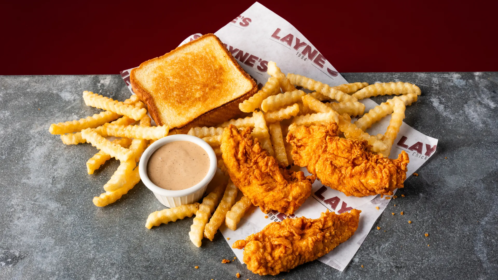 Photo of Layne's Chicken Fingers tenders, fries, toast and sauce