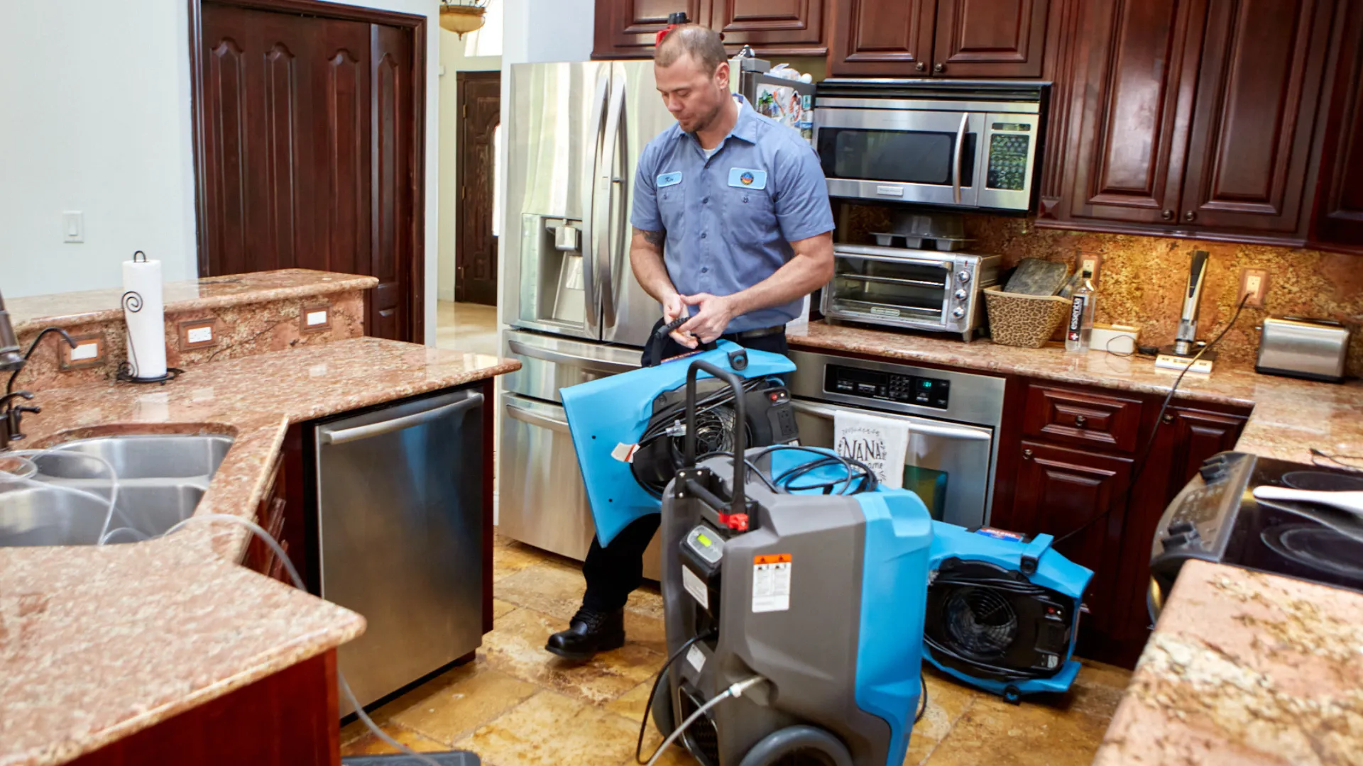 Photo of United Water Restoration Group team member working in kitchen